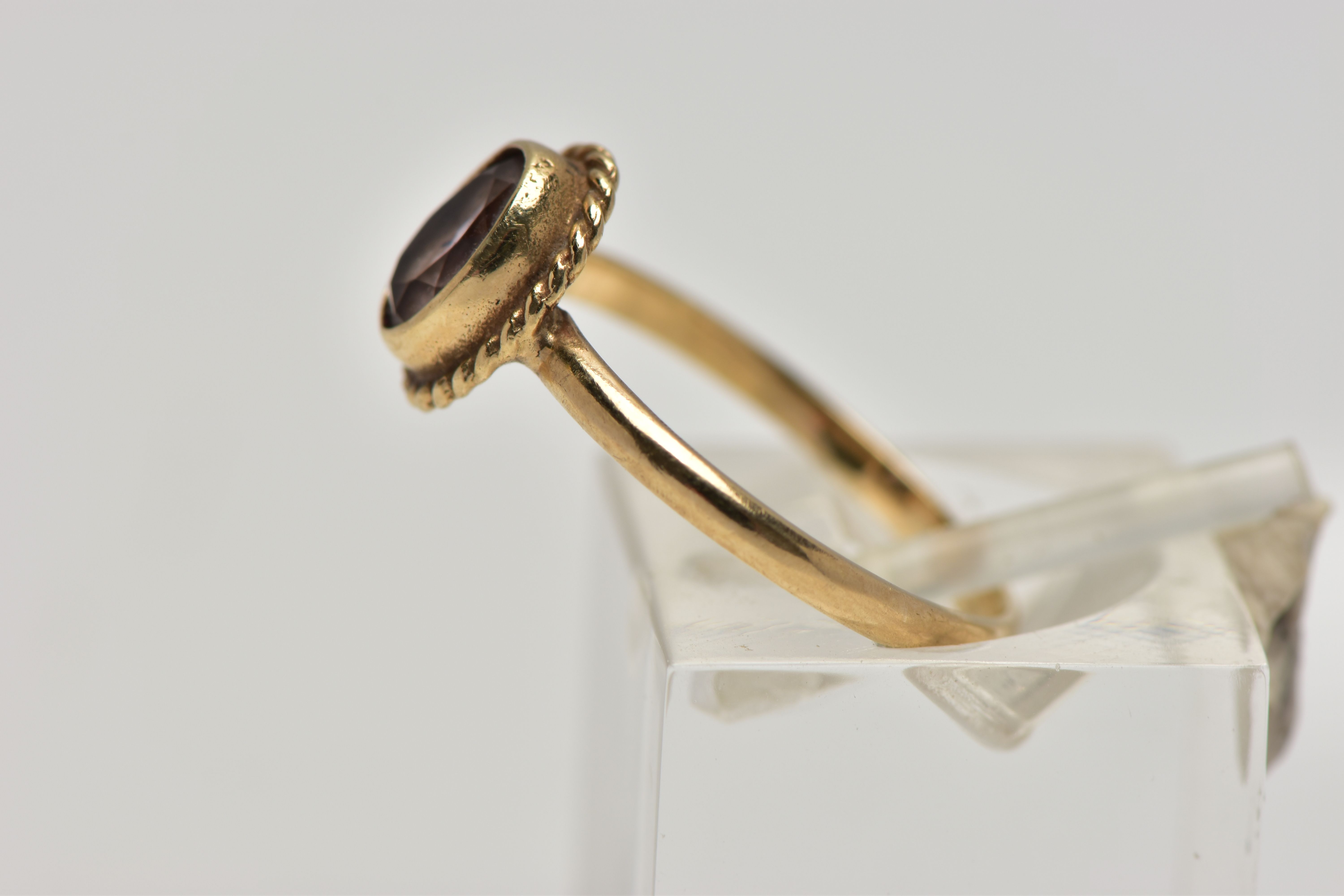 A 9CT GOLD AMETHYST SINGLE STONE RING, the oval cut amethyst within a collet setting, to the rope - Image 2 of 4