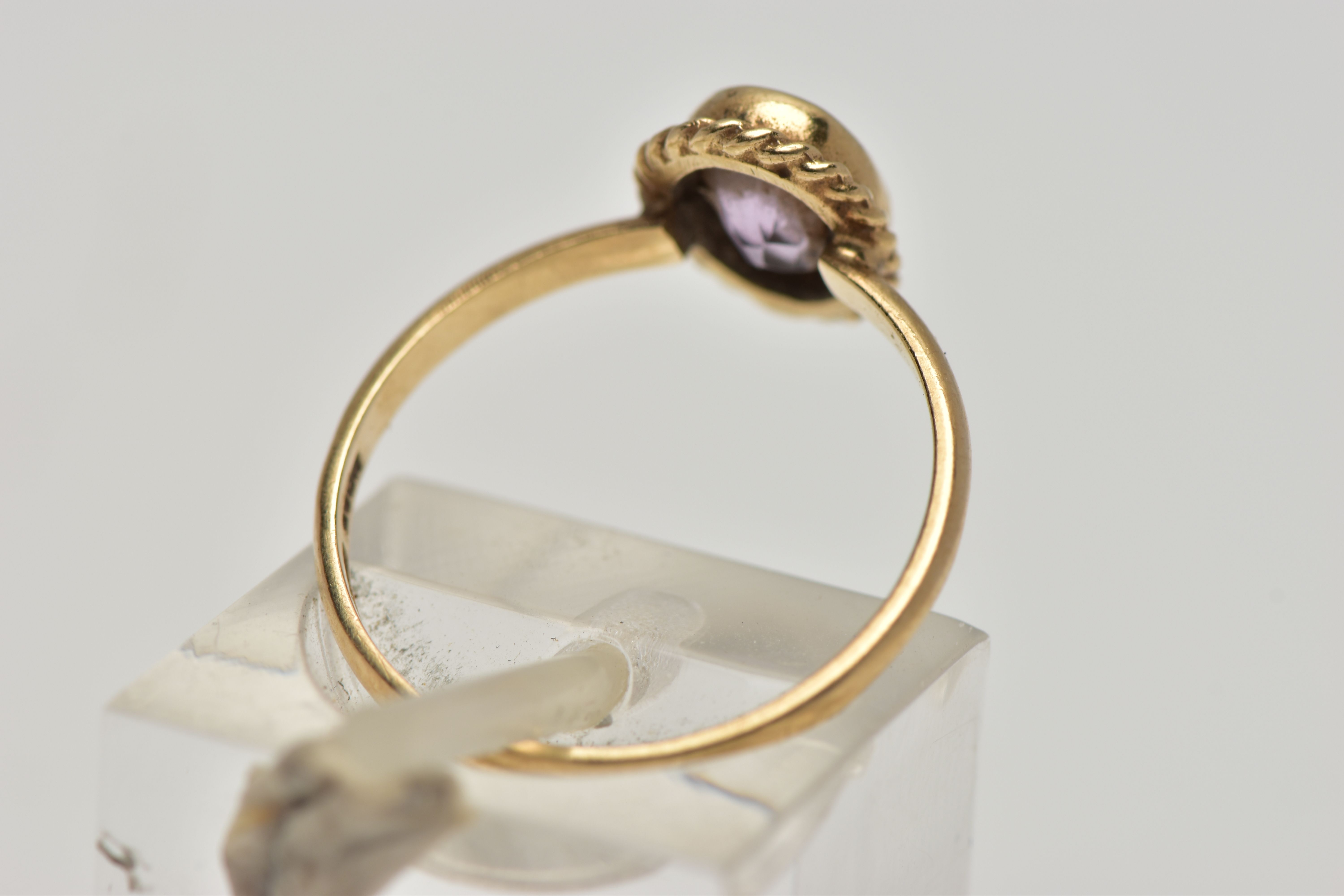 A 9CT GOLD AMETHYST SINGLE STONE RING, the oval cut amethyst within a collet setting, to the rope - Image 3 of 4