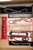 A BOX OF COSTUME JEWELLERY, to include a garnet bead necklace fitted with a lobster clasp, two