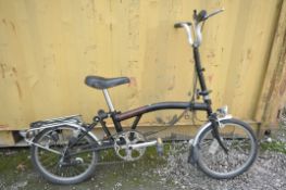 A BROMPTON THREE SPEED FOLDING BICYCLE in black colour some surface scratches and rust spots (all