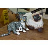 TWO MIKE HINTON CATS comprising a porcelain grey tabby cat with yellow glass eyes, signed on base No