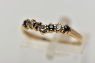 A 9CT GOLD SAPPHIRE AND CUBIC ZIRCONIA WISHBONE RING, the circular cut sapphire and alternately