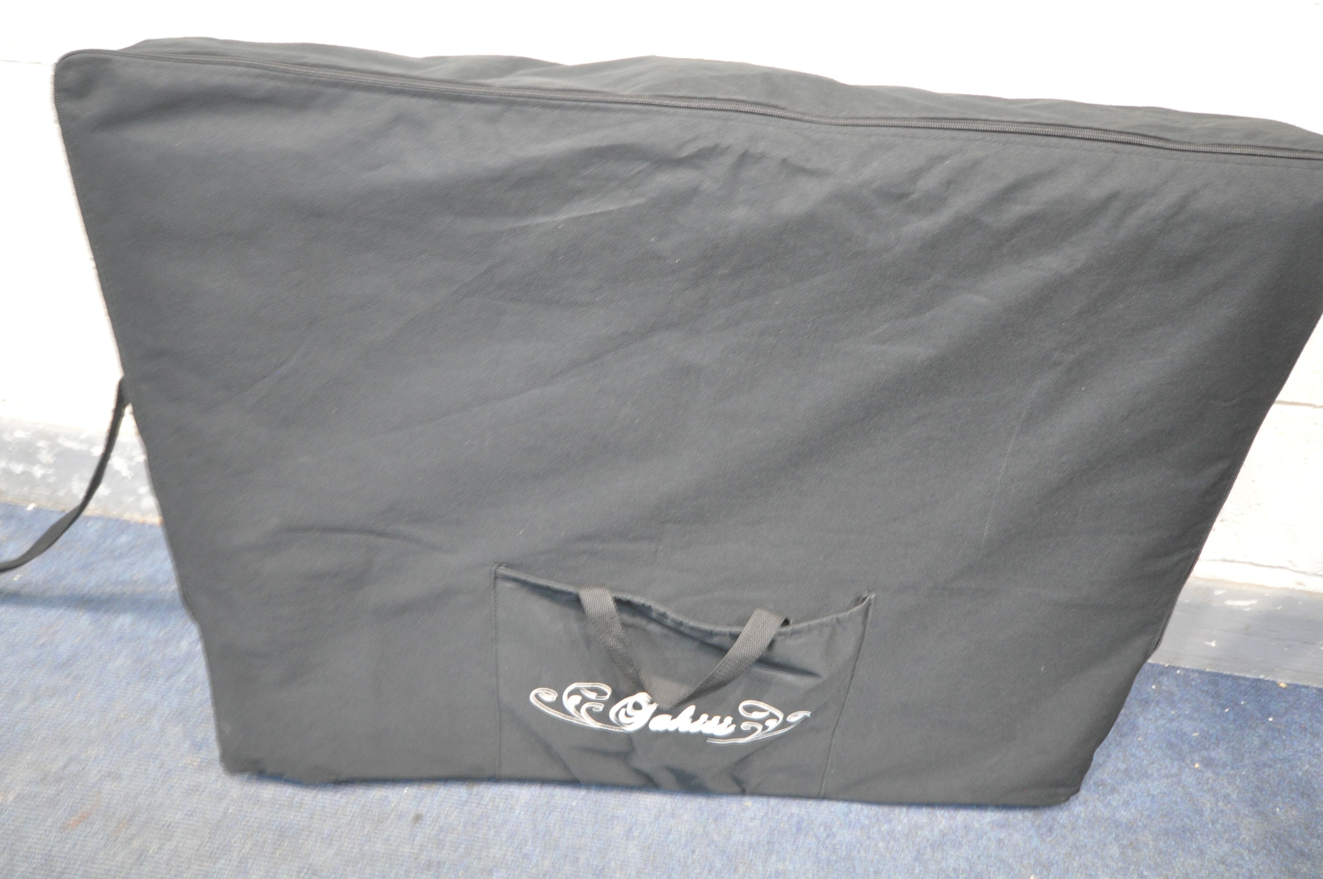 A CREAM LEATHERETTE FOLDING MASSAGE TABLE, with head and footrests (some stains, and a carry bag, - Image 4 of 4