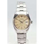 A STAINLESS STEEL 'ROLEX' OYSTER PERPETUAL, automatic movement, round champagne dial, signed 'Rolex'