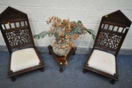 A PAIR OF HARDWOOD ORIENTAL CHAIRS, of very low proportions, with carved foliate detailing to