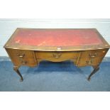A 20TH CENTURY MAHOGANY WRITING DESK, with a distressed red leather writing surface, five assorted