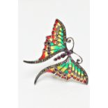 A WHITE METAL PLIQUE A JOUR GEM SET BUTTERFLY BROOCH, the ruby cabochon body, with circular cut ruby
