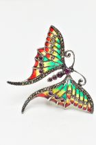 A WHITE METAL PLIQUE A JOUR GEM SET BUTTERFLY BROOCH, the ruby cabochon body, with circular cut ruby
