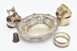 A SELECTION OF SILVER TABLEWARE, to include five early 20th century variously designed silver napkin