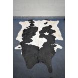 A LARGE BLACK AND WHITE COW HIDE RUG, length 240cm x width 210cm (good condition)