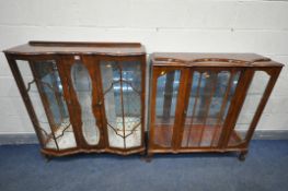 TWO WALNUT DISPLAY CABINETS, one with raised back, two glazed doors, a central glazed panel, on