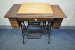 A 20TH CENTURY OAK SINGER TREDLE SEWING MACHINE, the sewing machine folds out of the top, and four