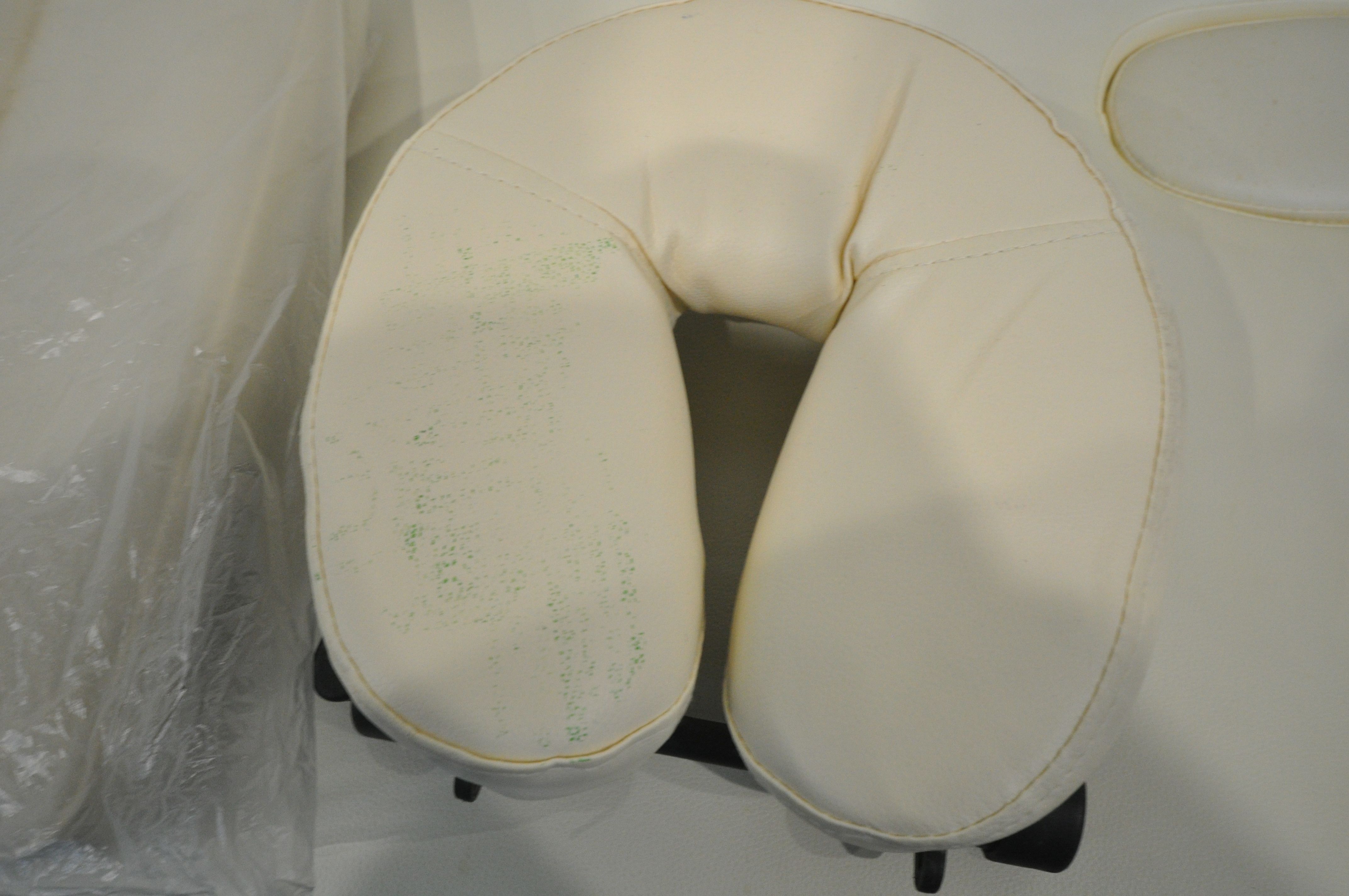 A CREAM LEATHERETTE FOLDING MASSAGE TABLE, with head and footrests (some stains, and a carry bag, - Image 2 of 4