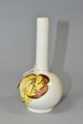 A MOORCROFT POTTERY BUD VASE, 'Leaves in the Wind' yellow and brown leaf pattern on a cream