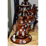 SEVEN PIECES OF MEASHAM BARGEWARE, comprising two large teapots, one having a teapot shaped finial