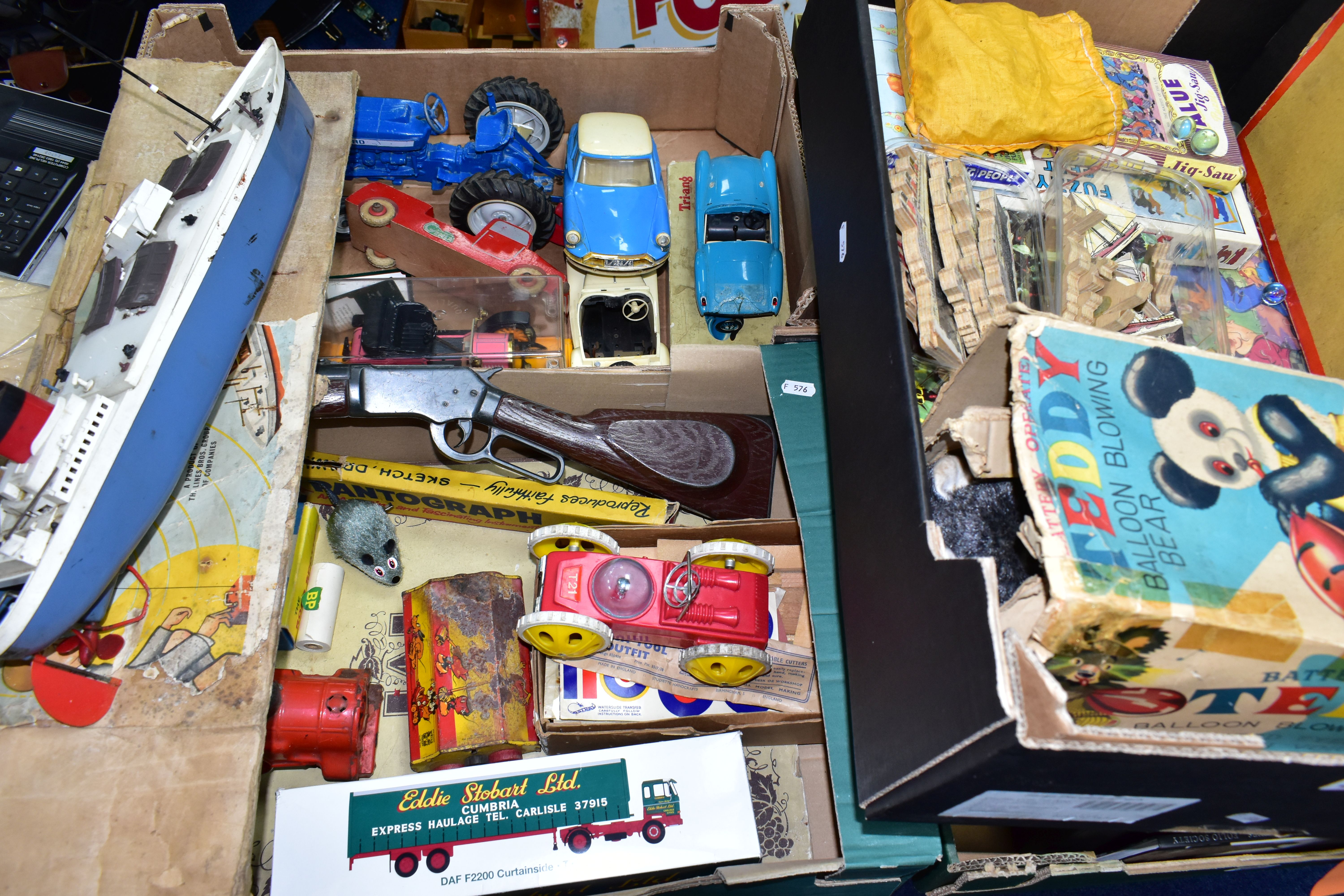 THREE BOXES OF VINTAGE TOYS AND JIGSAWS, to include a balsa wood aircraft making kit, a Tri-ang