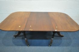 A GEORGIAN AND LATER MAHOGANY TWIN PEDESTAL DINING TABLE, with rounded ends, on tripod legs with