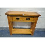 A SOLID OAK SIDE TABLE WITH A SINGLE DRAWER, and an undershelf, length 92cm x depth 31cm x height