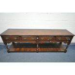 A REPRODUCTION GEORGIAN STYLE OAK DRESSER BASE, with four drawers, wavy apron, three turned and