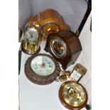 FIVE CLOCKS AND TWO BAROMETERS, comprising a Weston Super quartz wall clock, Hermle quartz