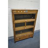 AN EARLY TO MID 20TH CENTURY OAK THREE SECTIONAL BOOKCASE, with three glazed hide and fall doors,