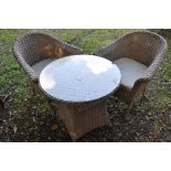 AN LG OUTDOOR RATTAN EFFECT GARDEN SET, to include a circular table, with a glass top, diameter 74cm