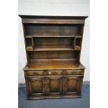 A REPRODUCTION OAK DRESSER, with three drawers, width 137cm x depth 49cm x depth 159cm x 85cm