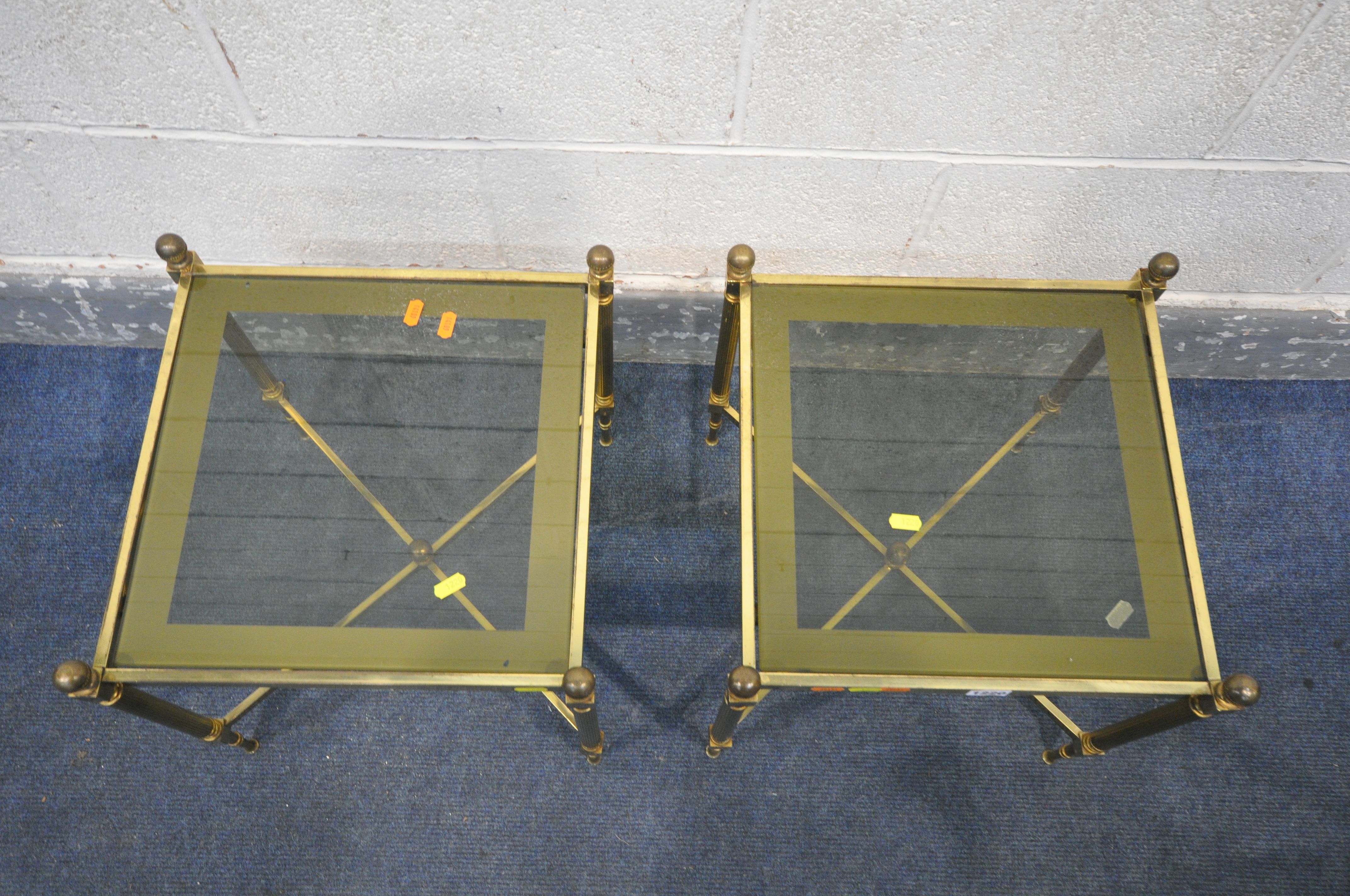 A PAIR OF MAISON JANSEN STYLE FRENCH BRASS SIDE TABLES, with smoked glass inserts, on Corinthian - Image 2 of 4