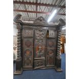 AN 18TH CENTURY AND LATER CONTINENTAL PALLADIAN STYLE CARVED OAK CABINET / ARMOIRE, the broken