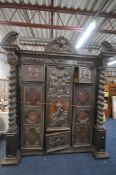 AN 18TH CENTURY AND LATER CONTINENTAL PALLADIAN STYLE CARVED OAK CABINET / ARMOIRE, the broken