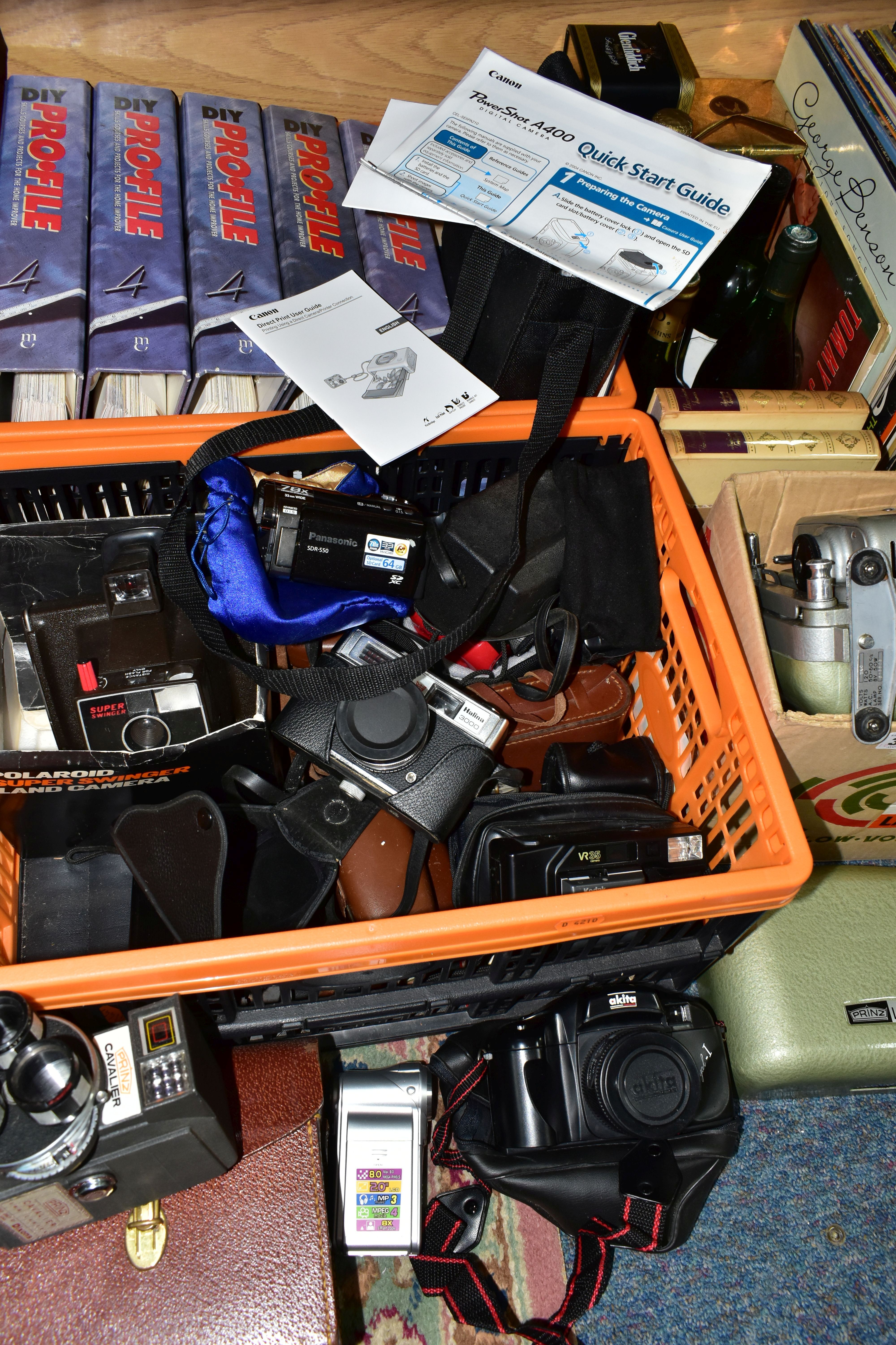 FOUR BOXES OF VINTAGE AND DIGITAL CAMERAS, to include a Prinz Lancer 8mm projector, a Prinz Cavalier