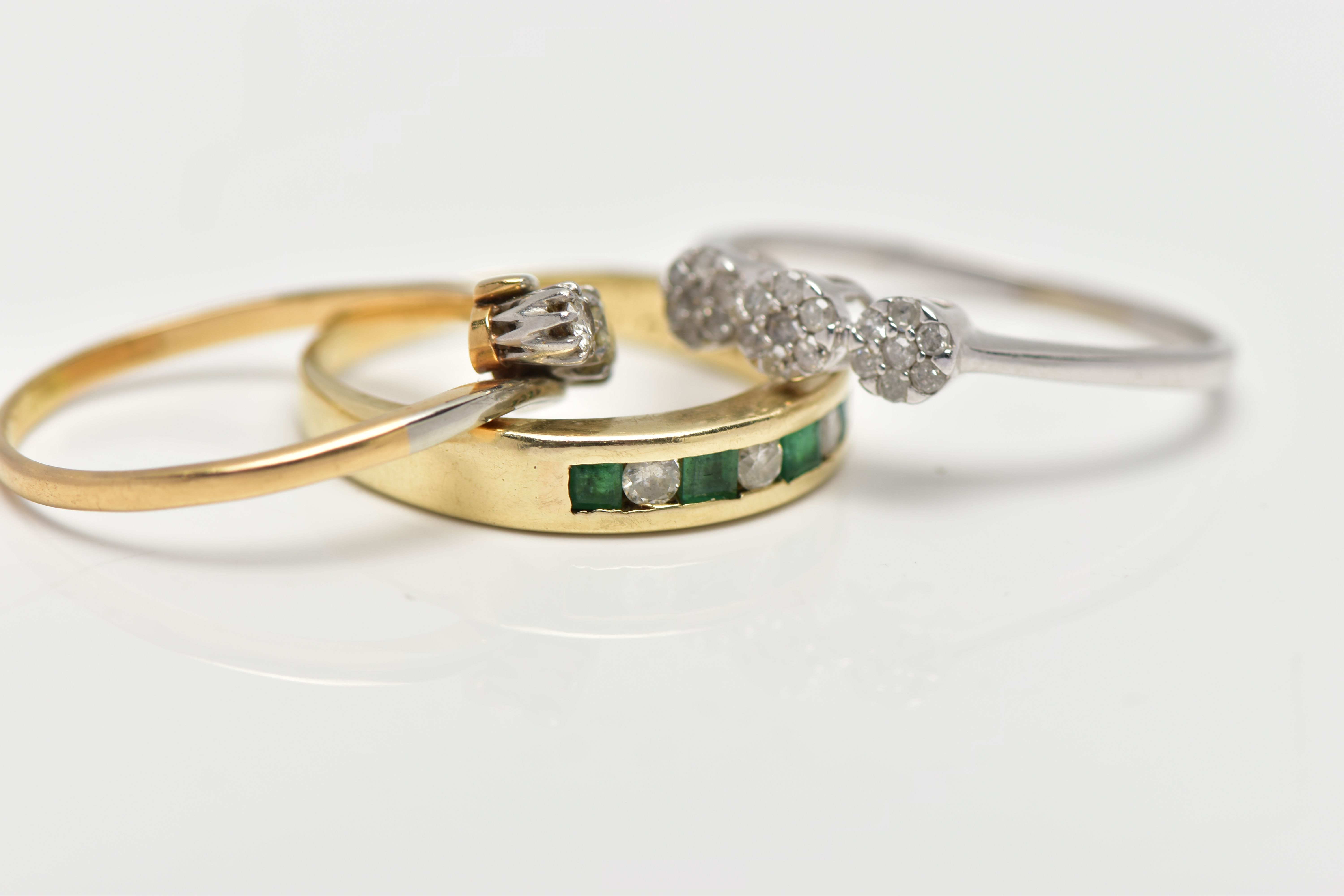 THREE GEM SET RINGS, the first a yellow metal half eternity ring set with four square cut emeralds - Image 2 of 4