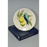 A BOXED MOORCROFT POTTERY COASTER IN THE BIRD AND LEMONS PATTERN ON A CREAM GROUND, impressed and