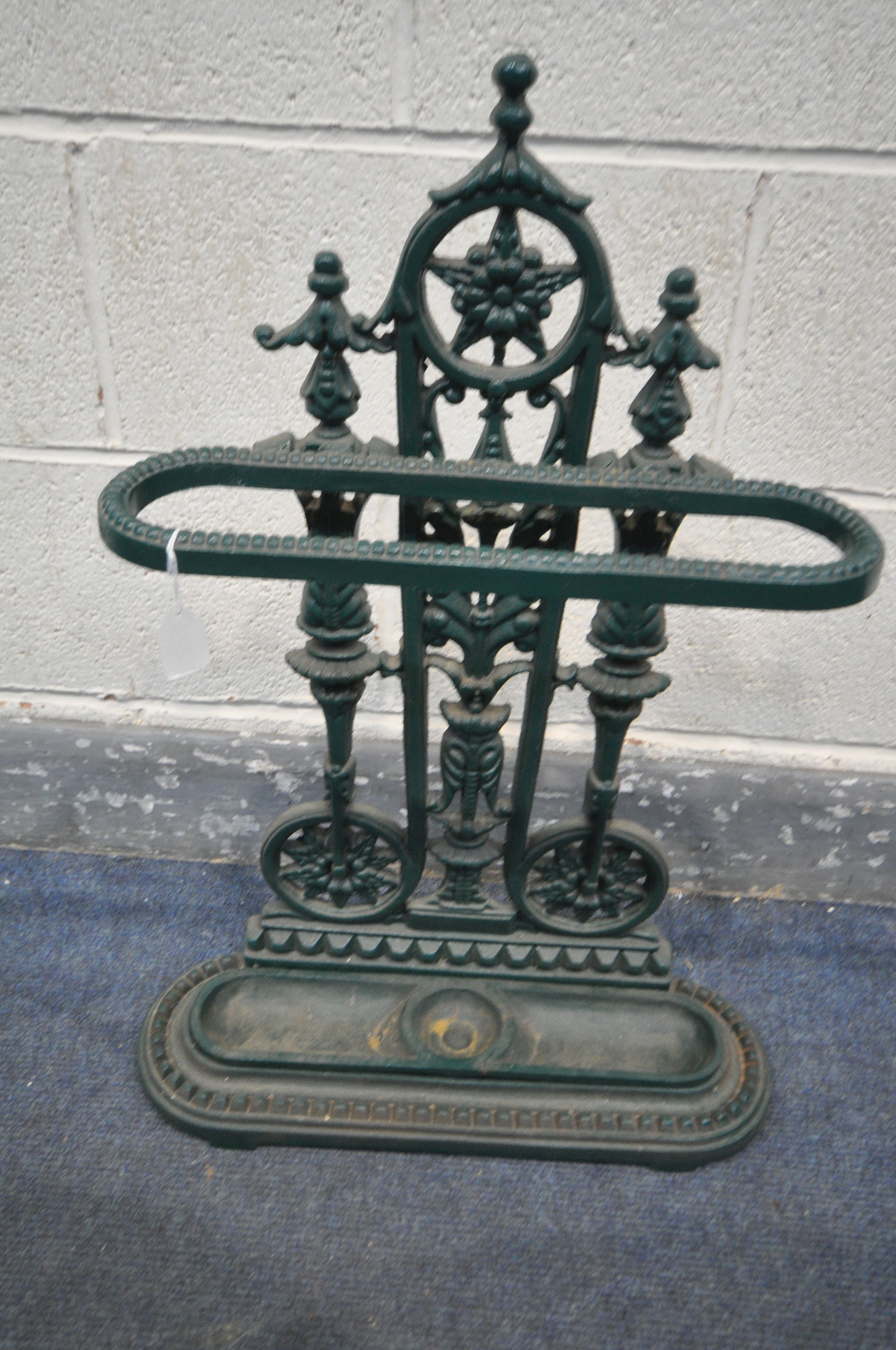 A CAST IRON UMBRELLA STAND, with drip tray, in a green finish, width 50cm x depth 16cm x height