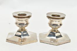 A PAIR OF SILVER CANDLE STICKS, two dwarf candle sticks, hexagonal weighted bases, approximate