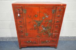 A CHINESE STYLE RED FINISH CABINET, with two cupboard doors enclosing two adjustable shelves, and an