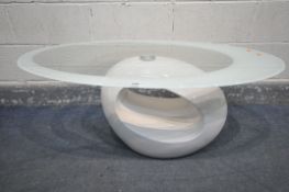 IN THE STYLE OF A DUBAI GLASS COFFEE TABLE BY TONIN CASA, an oval glass coffee table, with a white