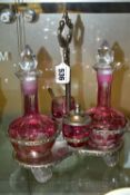 A PINK STAINED GLASS AND PLATED CRUET, the stand fitted with two bottles and two preserve pots,