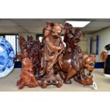 A GROUP OF SEVEN CARVED WOOD ORIENTAL FIGURES, comprising two large Shou Lao (God of Longevity)