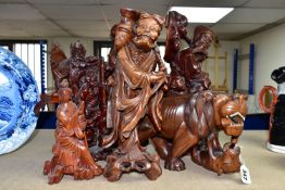 A GROUP OF SEVEN CARVED WOOD ORIENTAL FIGURES, comprising two large Shou Lao (God of Longevity)