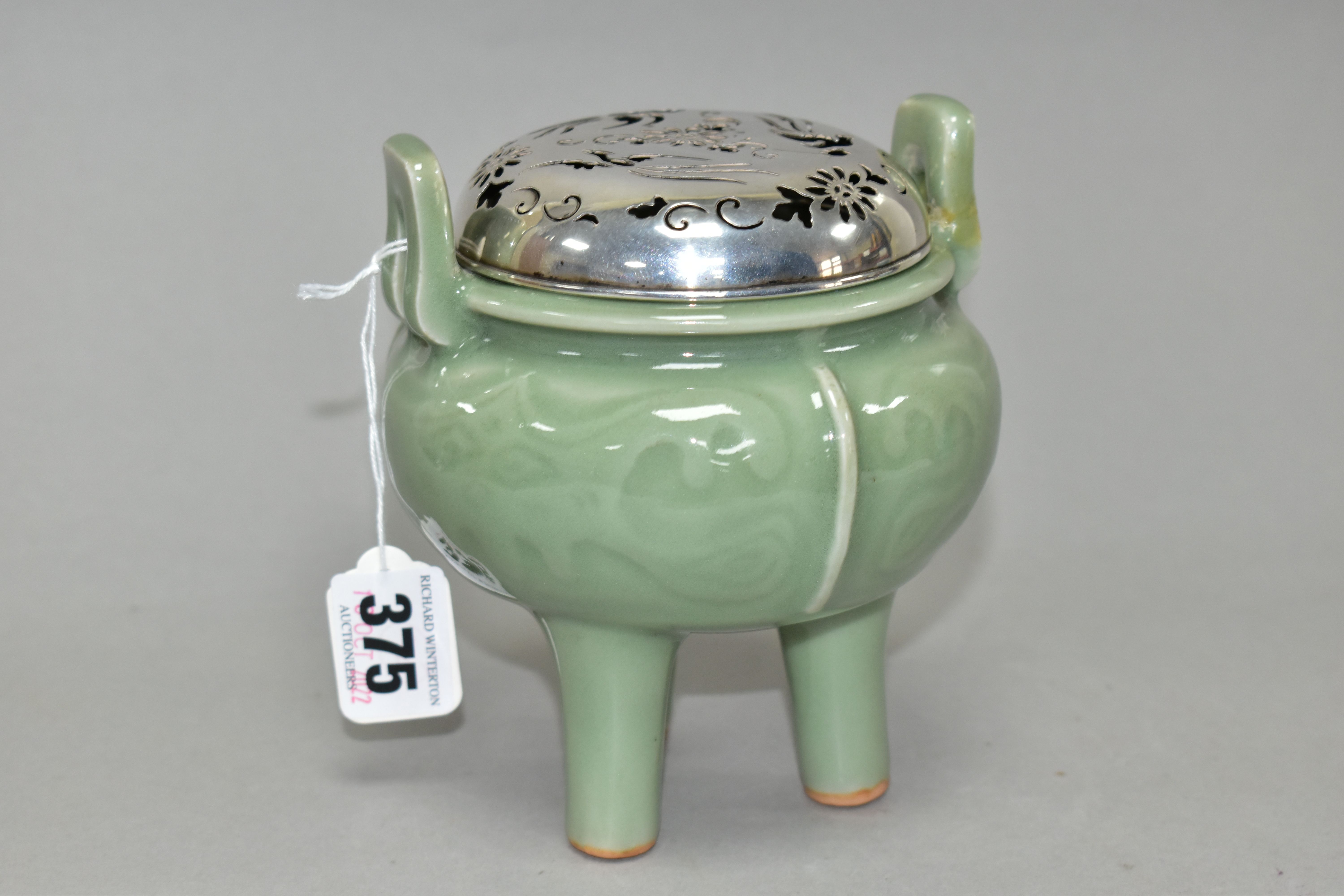 A 20TH CENTURY CHINESE PORCELAIN CELADON GLAZED TWIN HANDLED CENSER WITH A PIERCED WHITE METAL