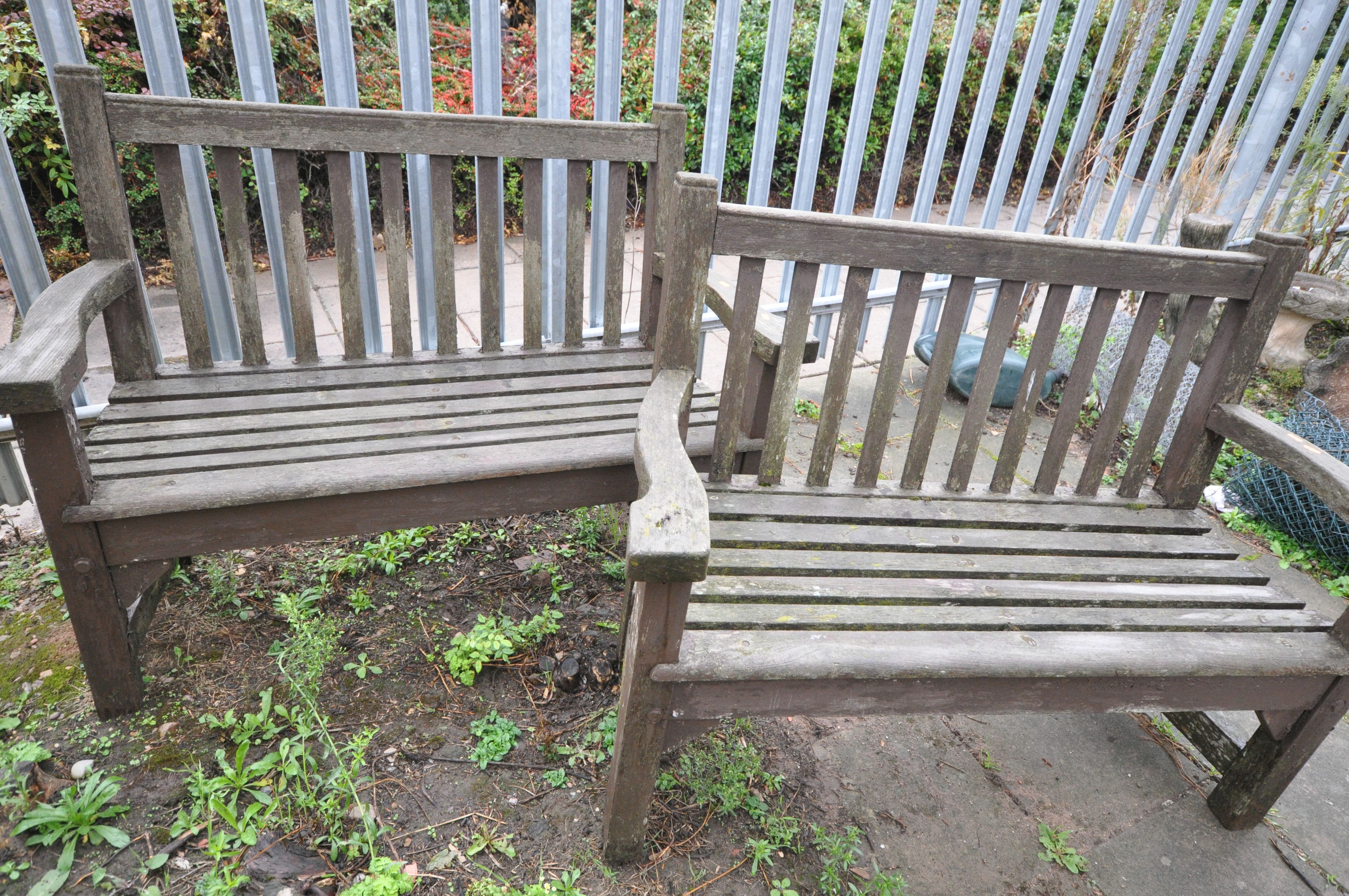 A PAIR OF WOODEN GARDEN BENCHES, width 129cm (Condition:- Weathered)