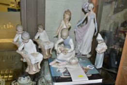 A GROUP OF SEVEN LLADRO FIGURINES TOGETHER WITH A LLADRO CATALOGUE, comprising a 2000/2001 edition
