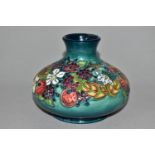 A MOORCROFT POTTERY CAROUSEL PATTERN VASE, of squat form, tube lined with flowers, berries and