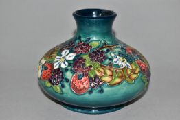 A MOORCROFT POTTERY CAROUSEL PATTERN VASE, of squat form, tube lined with flowers, berries and