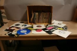 A TRAY CONTAINING OVER ONE HUNDRED AND TWENTY 7in SINGLES from the 1980s including a blue vinyl copy