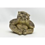 A RECONSTITUTED STONE GARDEN ORNAMENT IN THE FORM OF A SEATED GARGOYLE, the figure is of weathered