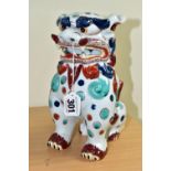 AN ORIENTAL STYLE DOG OF FO CERAMIC FIGURE, in seated position, decorated with red, green and blue