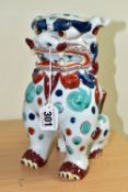 AN ORIENTAL STYLE DOG OF FO CERAMIC FIGURE, in seated position, decorated with red, green and blue