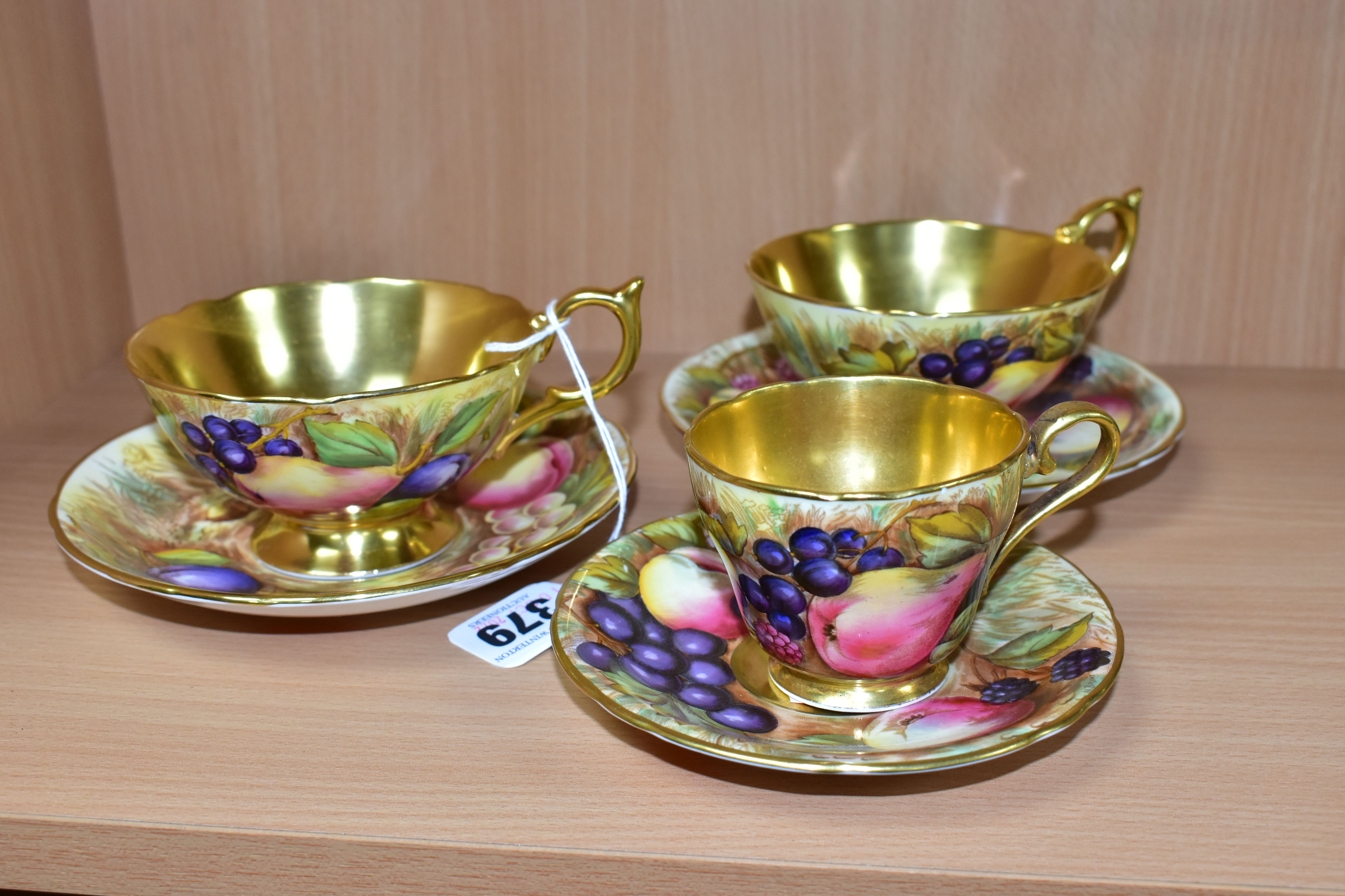 TWO AYNSLEY FRUIT DECORATED TEA CUPS AND SAUCERS SIGNED D.JONES AND A COFFEE CUP AND SAUCER SIGNED